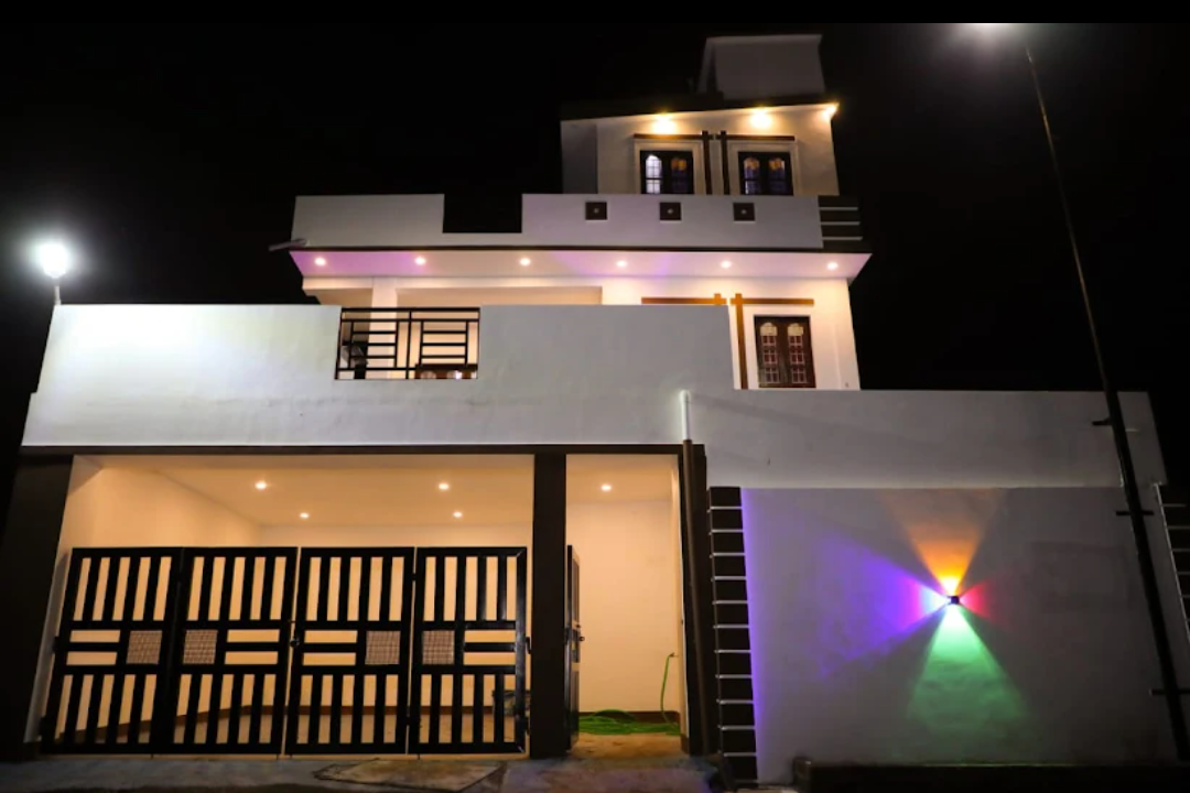 Contemporary two-storey home lit at night