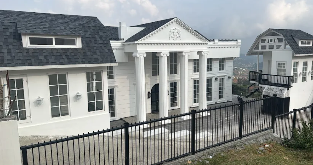 Grand white colonial mansion built by MCB Brothers